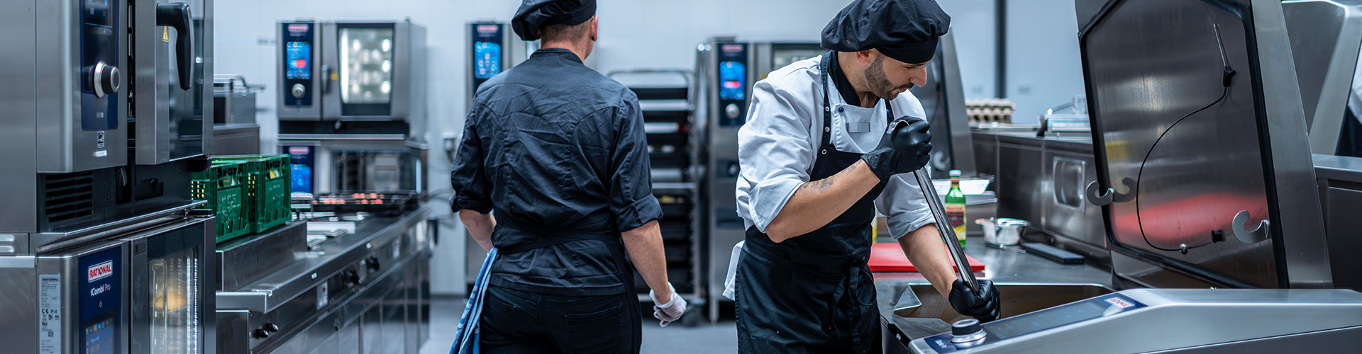 Gastech engineers servicing Rational combi ovens in a commercial kitchen